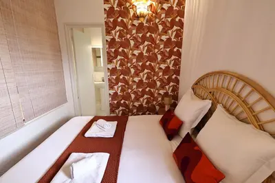 a small room with a bed and a window at Sous le Pin - Villa paisible face aux îles Lavezzi in Bonifacio