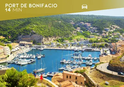 a view of a marina with boats in the water at Sous le Pin - Villa paisible face aux îles Lavezzi in Bonifacio