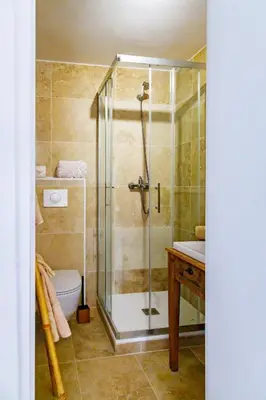 a bathroom with a shower and a toilet and a sink at U Vermentinu in Aghione