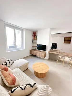 a living room with a couch and a table at Charmant T3 au coeur d'Ajaccio in Ajaccio