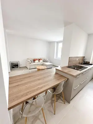 a kitchen with a wooden counter top in a room at Charmant T3 au coeur d'Ajaccio in Ajaccio