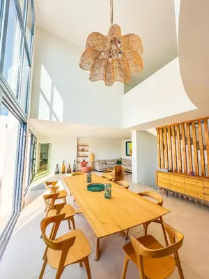 a dining room with a wooden table and chairs at Villa Alimea San Ciprianu in Cirendinu