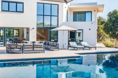 a villa with a swimming pool and a house at Villa Alimea San Ciprianu in Cirendinu