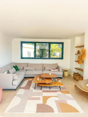 a living room with a couch and a table at Villa Alimea San Ciprianu in Cirendinu