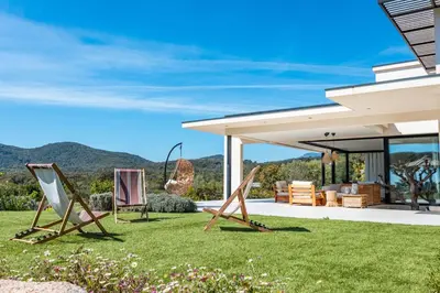 a group of lawn chairs in the yard of a house at Villa Alba Di Pinarello in Pinarellu