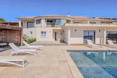 a villa with a swimming pool and a house at Villa Ghjiseppina Di Pinarello in Pinarellu