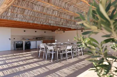 a dining room with a table and chairs at Villa Ghjiseppina Di Pinarello in Pinarellu