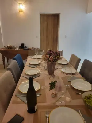 a long table with plates and wine glasses on it at Maison - chambres d'hotes in Prunelli-di-Fiumorbo