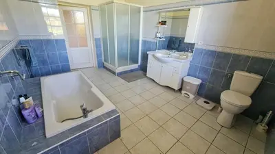 a bathroom with a tub and a toilet and a sink at Maison - chambres d'hotes in Prunelli-di-Fiumorbo