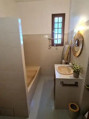 a bathroom with a sink and a tub and a mirror at Maison - chambres d'hotes in Prunelli-di-Fiumorbo