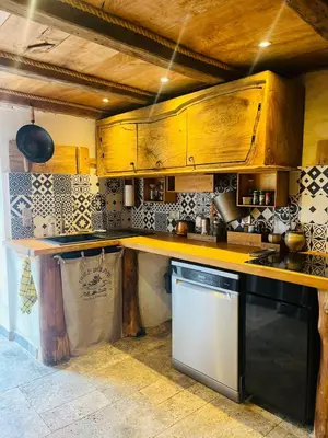 a kitchen with wooden cabinets and a dishwasher at Charming house with sea view Emily in Porri in Porri