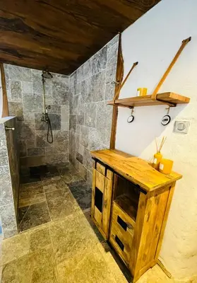 a bathroom with a wooden sink and a shower at Charming house with sea view Emily in Porri in Porri