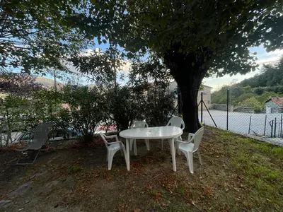 a white table and chairs under a tree at CASA Marie-PAULINE in Sampolo