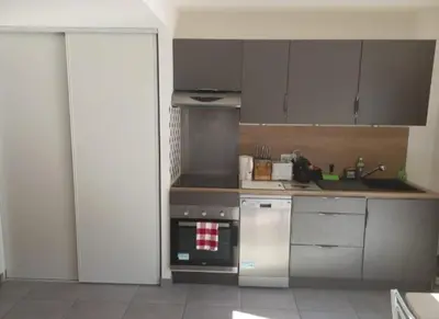 a kitchen with a stove top oven next to a sink at porticcio in Porticcio