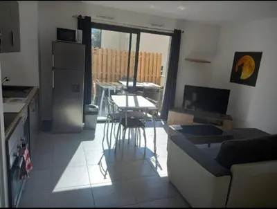 a kitchen and living room with a couch and a table at porticcio in Porticcio