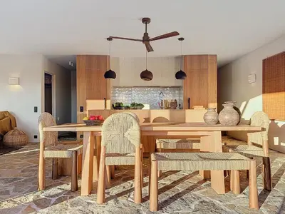 a dining room with a wooden table and chairs at Villa Sabbia in Lecci