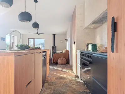 a kitchen with a sink and a stove top oven at Villa Sabbia in Lecci