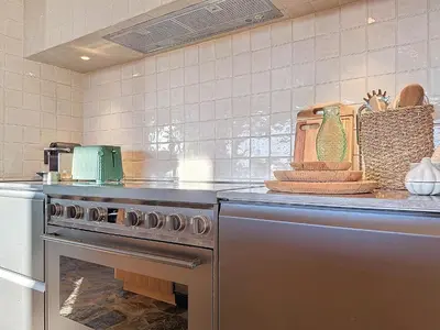 a kitchen with a stainless steel oven and a counter at Villa Sabbia in Lecci