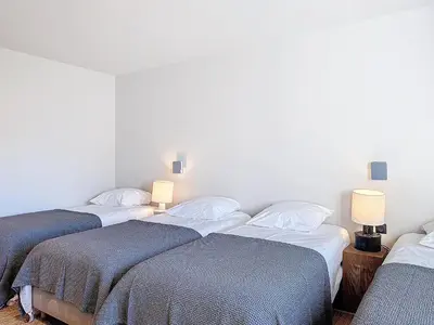 a group of three beds in a room with lamps at Villa Sabbia in Lecci