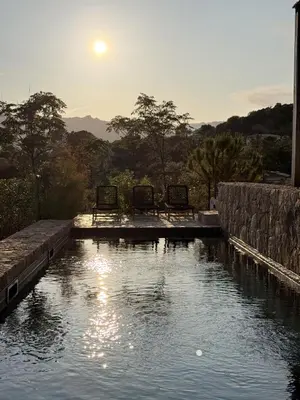 a pool of water with two chairs in it at Villa Sabbia in Lecci