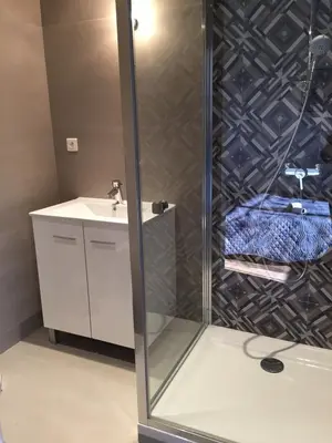 a shower in a bathroom with a sink at T2 dans villa avec piscine in Porto-Vecchio