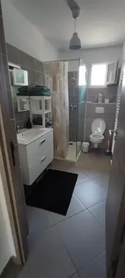 a bathroom with a shower and a toilet and a sink at Haut de villa in Cervione