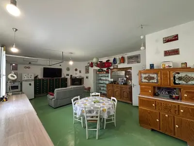 a living room with a table and chairs in a room at Bas de villa Sarrola Carcopino in Sarrola-Carcopino