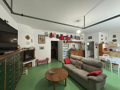 a living room with a couch and a table at Bas de villa Sarrola Carcopino in Sarrola-Carcopino