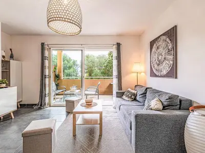 a living room with a couch and a table at Apartment Clos Vignola by Interhome in Porto-Vecchio