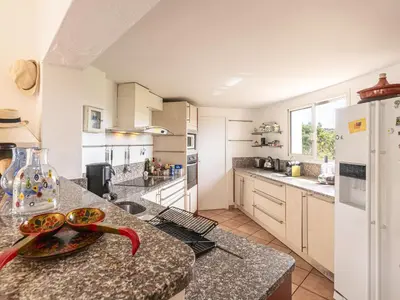 a kitchen with a counter top with a white refrigerator at Holiday Home Villa Marina by Interhome in Porto-Vecchio