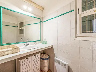 a bathroom with a sink and a mirror at Holiday Home Villa Marina by Interhome in Porto-Vecchio