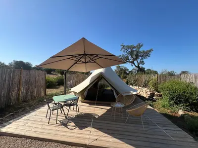 a tent with chairs and a table and a table and chairs at Le Tipi in Lecci