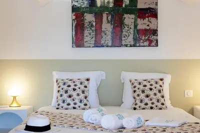 a bed with two pillows and a painting above it at Balamb Garden A Cinarchesa in Ajaccio