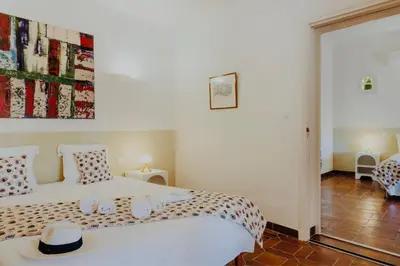 a bedroom with a white bed with a hat on it at Balamb Garden A Cinarchesa in Ajaccio