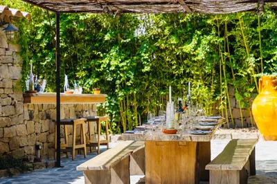 a long table with glasses on it under a pergola at Balamb Garden A Cinarchesa in Ajaccio