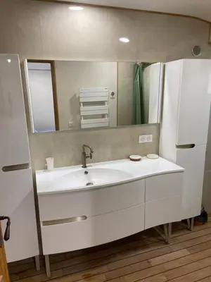 a bathroom with a sink and a refrigerator at T2 bala in Porto-Vecchio