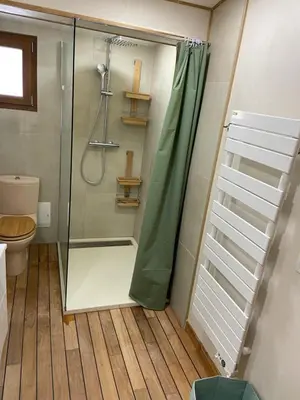 a shower with a glass door in a bathroom at T2 bala in Porto-Vecchio
