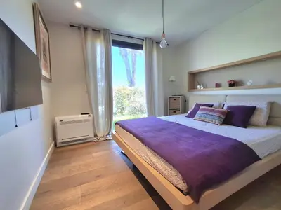 a bedroom with a large bed and a window at Villa bord de mer avec piscine in Lucciana