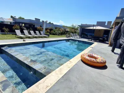 a large swimming pool with a donut sitting next to it at Villa bord de mer avec piscine in Lucciana