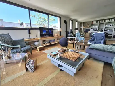 a living room with a couch and a table with a chessboard at Villa bord de mer avec piscine in Lucciana