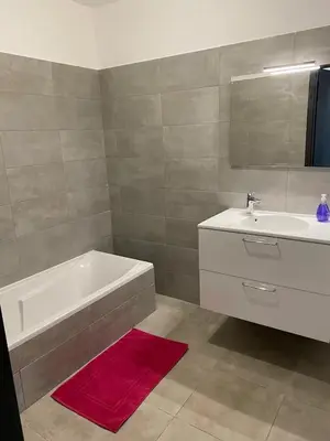 a bathroom with a white tub and a sink at Salario-1 in Ajaccio