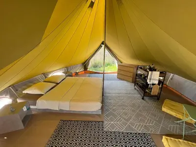 a bedroom in a tent with a bed in it at Le Tipi 2 in Lecci