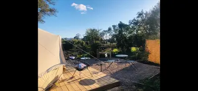 a tent with chairs and tables in a yard at Le Tipi 2 in Lecci