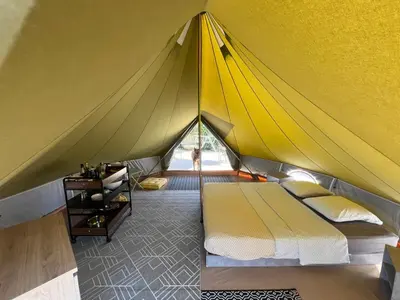 a yellow tent with a bed in a room at Le Tipi 2 in Lecci