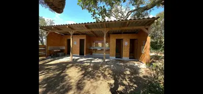 a small house with a roof on a dirt field at Le Tipi 2 in Lecci