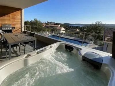 a bath tub filled with water on top of a house at La résidence Location Pinarello in Mangialla