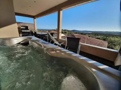 a hot tub in the middle of a house at La résidence Location Pinarello in Mangialla