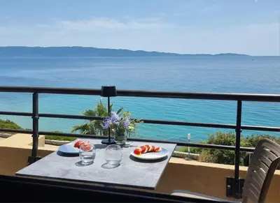 a table on a balcony with a view of the ocean at Beau Studio vue sur mer, route des sanguinaires in Ajaccio