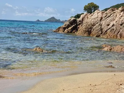 a beach with rocks in the water and the ocean at Beau Studio vue sur mer, route des sanguinaires in Ajaccio