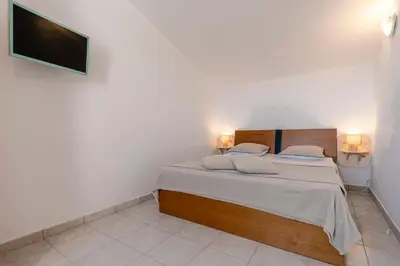 a bedroom with a bed with a tv on the wall at Prunete - Piscine - Vue mer in Cervione
